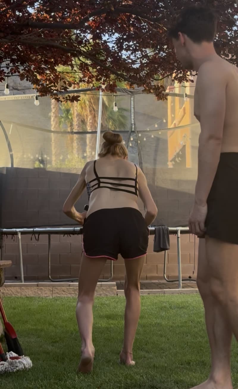 Michael coaching Bree, a Functional Patterns trainer with scoliosis, through a hinge